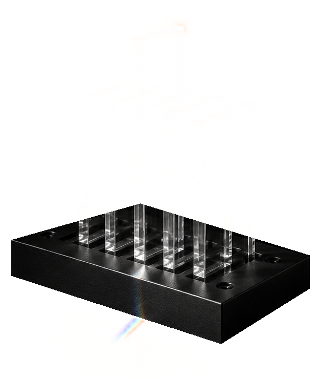 A row of clear glass slabs standing in a machined black base.